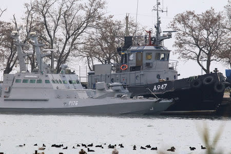 Seized Ukrainian ships, small armoured artillery ships and a tug boat, are seen anchored in a port of Kerch, Crimea November 26, 2018. REUTERS/Pavel Rebrov