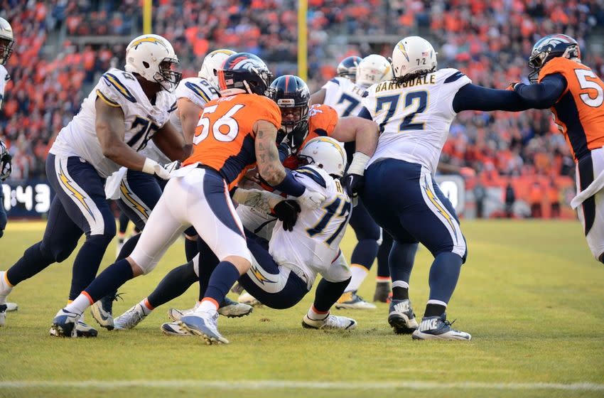 Jan 3, 2016; Denver, CO, USA; Denver Broncos defensive end Derek Wolfe (95) and linebacker Shane Ray (56) sack San Diego Chargers quarterback Philip Rivers (17) in the first quarter at Sports Authority Field at Mile High. Mandatory Credit: Ron Chenoy-USA TODAY Sports