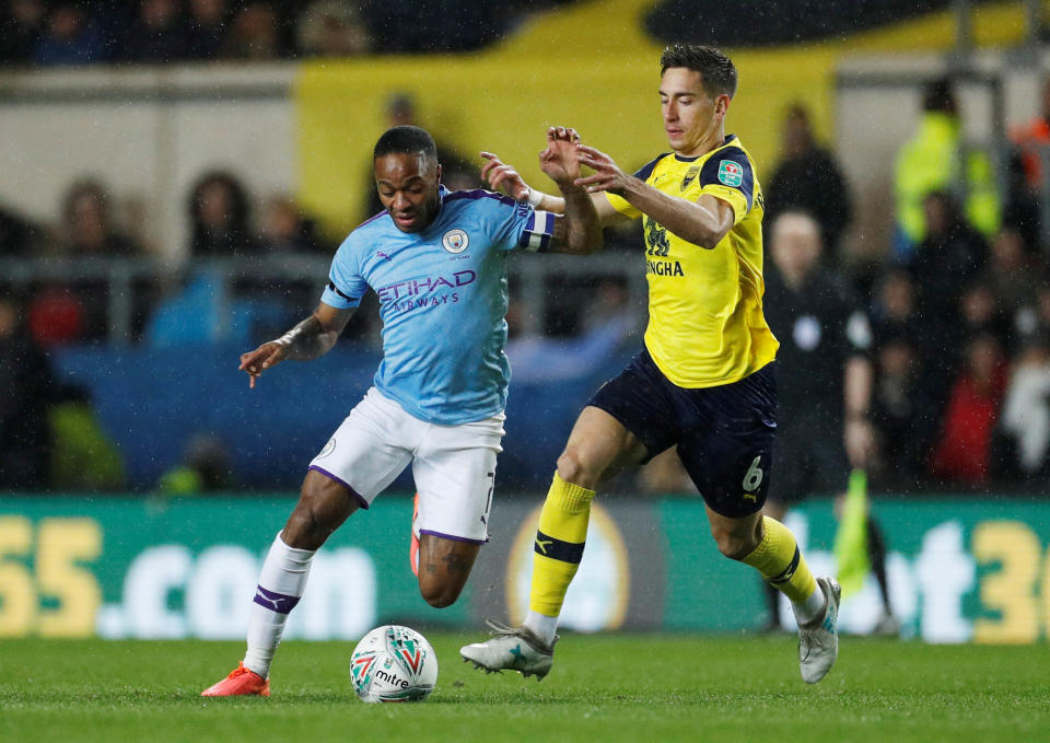 Soccer Football - Carabao Cup - Quarter Final - Oxford United v Manchester City - Kassam Stadium, Oxford, Britain - December 18, 2019  Manchester City's Raheem Sterling in action with Oxford United's Alex Rodriguez    Action Images via Reuters/John Sibley  EDITORIAL USE ONLY. No use with unauthorized audio, video, data, fixture lists, club/league logos or "live" services. Online in-match use limited to 75 images, no video emulation. No use in betting, games or single club/league/player publications.  Please contact your account representative for further details.