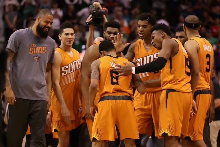 Tyler Ulis (No 8) of the Phoenix Suns is congratulated by teammates after hitting the game winning three pointer against the Boston Celtics, at Talking Stick Resort Arena in Phoenix, Arizona, on March 5, 2017