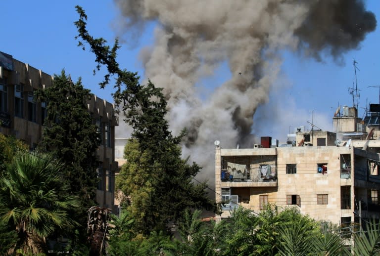 Smoke rises from reported opposition fire from buildings in an eastern government-held neighbourhood of the northern Syrian city of Aleppo