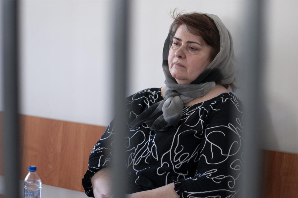 Zarema Musayev sits behind bars in a courtroom a in Grozny, Russia, Tuesday, July 4, 2023. Musayev is the mother of two local activists who have challenged Chechen authorities and has been in custody in Chechnya since her arrest in January 2022. Unidentified masked assailants in the Russian province of Chechnya attacked and beat Novaya Gazeta journalist Elena Milashina and lawyer Alexander Nemov on Tuesday, who had just arrived in Chechnya to attend the trial of Musayeva. (AP Photo)