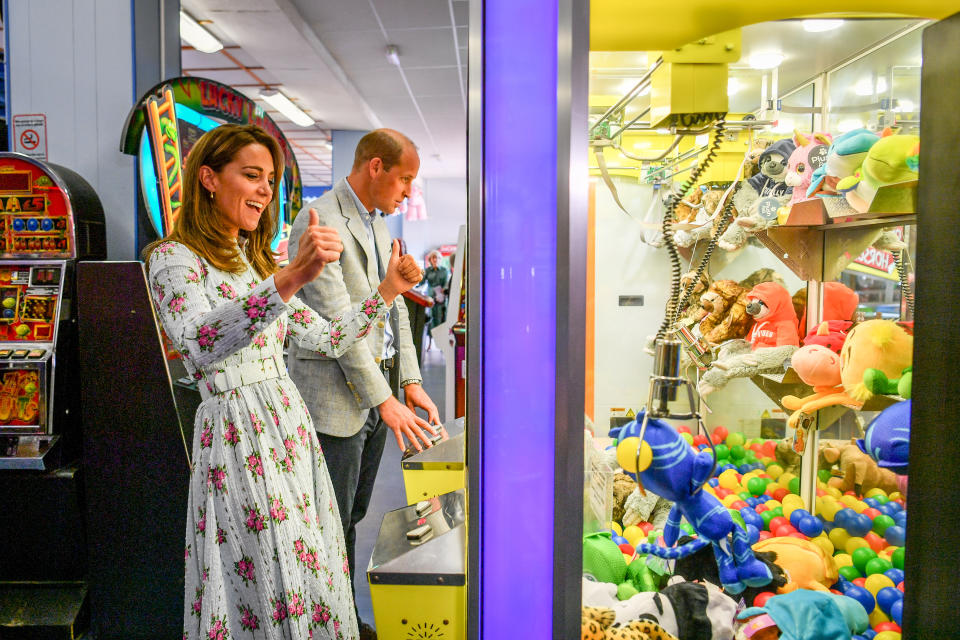 The Duke and Duchess of Cambridge play a grab a teddy game as the Duchess picks up a blue toy and celebrates with thumbs up, only for it to slip from the claws before reaching the winning chute, during their visit to Barry Island, South Wales, to speak to local business owners about the impact of COVID-19 on the tourism sector.