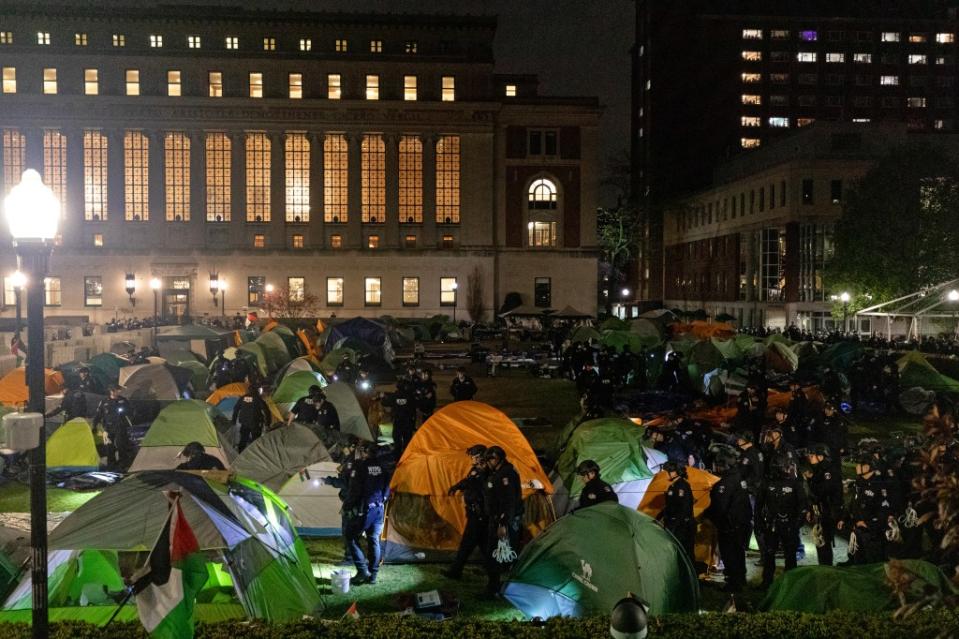 NYPD officers in riot gear enter Columbia University’s encampment as they evict a building that had been barricaded by anti-Israel protesters. AFP via Getty Images