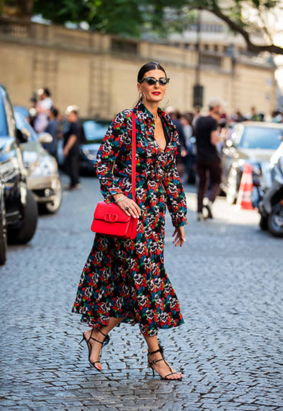 Woman-wears-brightly-printed-floral-dress