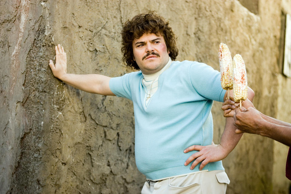 Jack Black leaning against a building