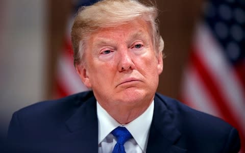 President Donald Trump listens during a dinner with European business leaders at the World Economic Forum - Credit: Evan Vucci/AP