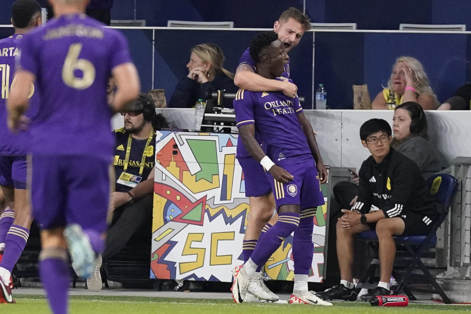 Orlando City's Iván Angulo, and Duncan McGuire, rear, celebrate a goal against Nashville SC during the first half of an MLS playoff soccer match Tuesday, Nov. 7, 2023, in Nashville, Tenn. (AP Photo/George Walker IV)