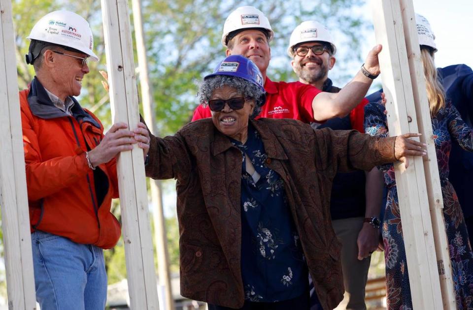 Opal Lee, center, holds onto the framework of what will be her new home during a wall raising ceremony on Thursday, March 21, 2024, in Fort Worth. Texas Capital, Habitat for Humanity and HistoryMaker Homes joined together to help Lee rebuild a home on the same lot that her family had a home on. In 1939 a white mob drove her family from the home and set fire to it.