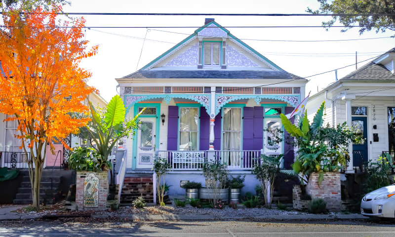 New Orleans, Louisiana United States - December 25 2020: a colorful shotgun house with plants in a neighborhood