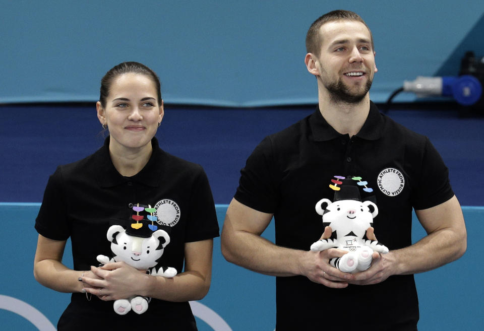 Alexander Krushelnitsky (right) won the mixed-doubles curling bronze medal with his wife Anastasia Bryzgalova. (AP)