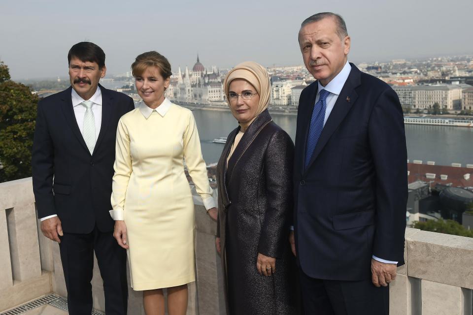 Turkish President Recep Tayyip Erdogan, right, his wife, Emine Erdogan, second right, Hungarian President Janos Ader and his wife Anita Herczegh pose for the photographers on the terrace of the presidential Alexander Palace in Budapest, Hungary, Monday, Oct. 8, 2018. Erdogan is paying a two-day official visit to Hungary. (Tamas Kovacs/MTI via AP)