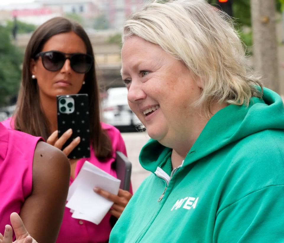 Amy Mizialko, President of the Milwaukee Teachers Education Association, is interviewed by a national ABC News TV network as Moms for Liberty Ozaukee County co-founder Amber Schroeder video records the interview during a demonstration by the MTEA, demanding local venues refuse to host events for Moms for Liberty, outside the Pfister Hotel on East Wisconsin Avenue in Milwaukee on Tuesday, Aug. 22, 2023.