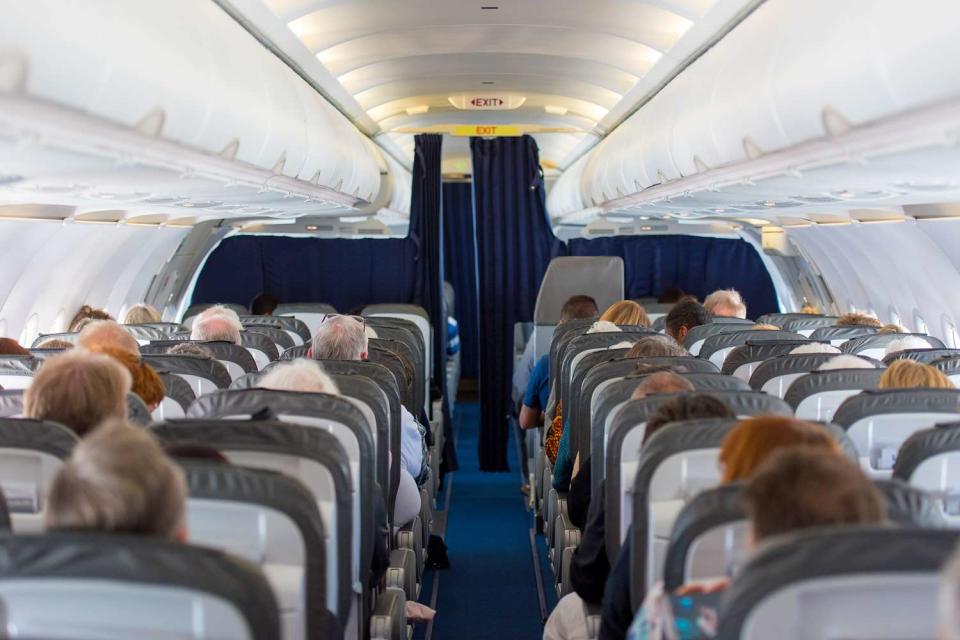 <p>Getty</p> Stock image of passengers on a flight. 
