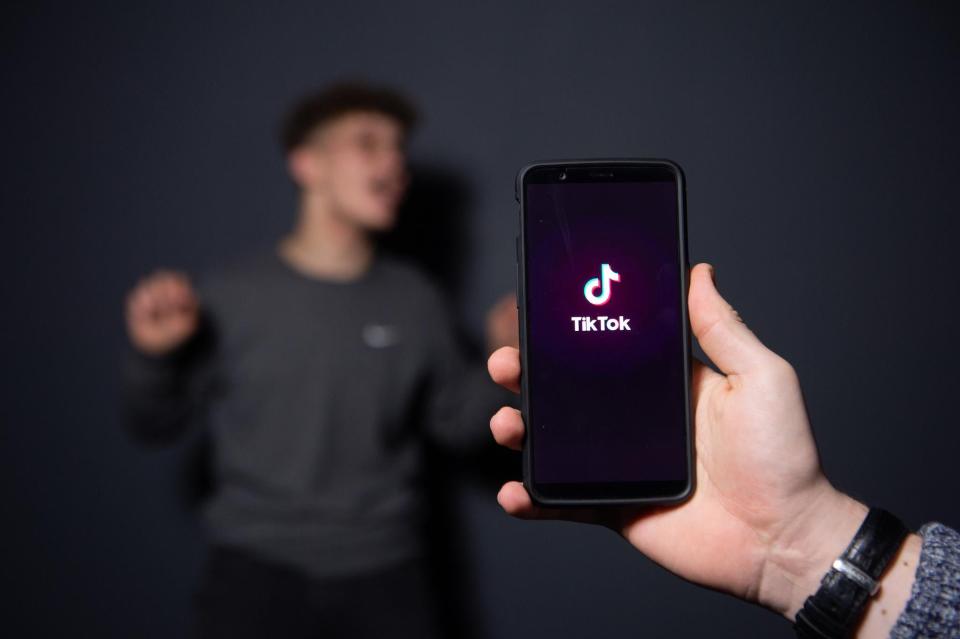 An AFP collaborator poses for a picture using the smart phone application TikTok on December 14, 2018 in Paris: AFP via Getty Images