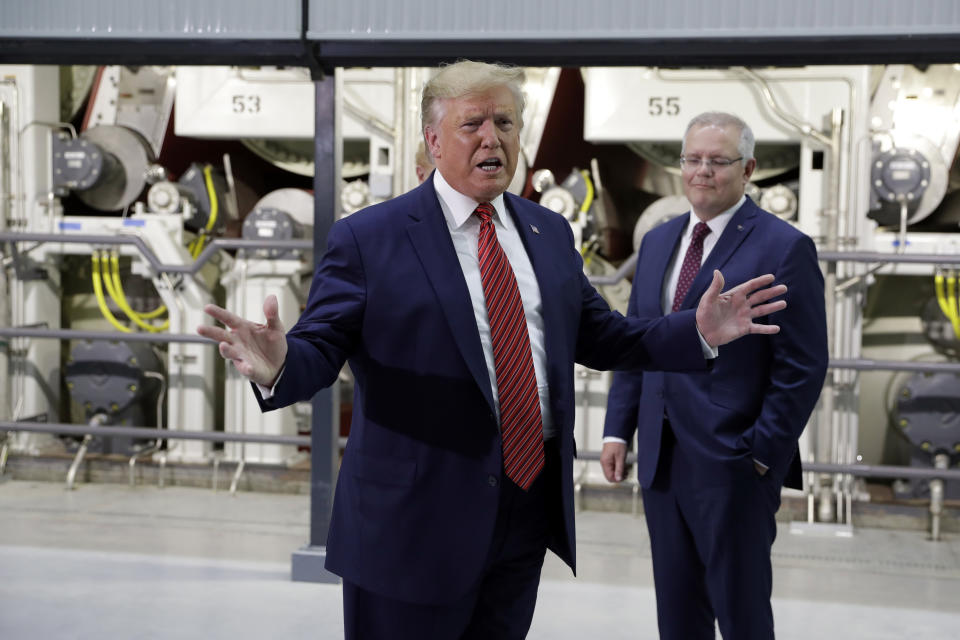 President Donald Trump speaks as Australian Prime Minister Scott Morrison, right, listens during a tour of Pratt Industries, Sunday, Sept 22, 2019, in Wapakoneta, Ohio. (AP Photo/Evan Vucci)