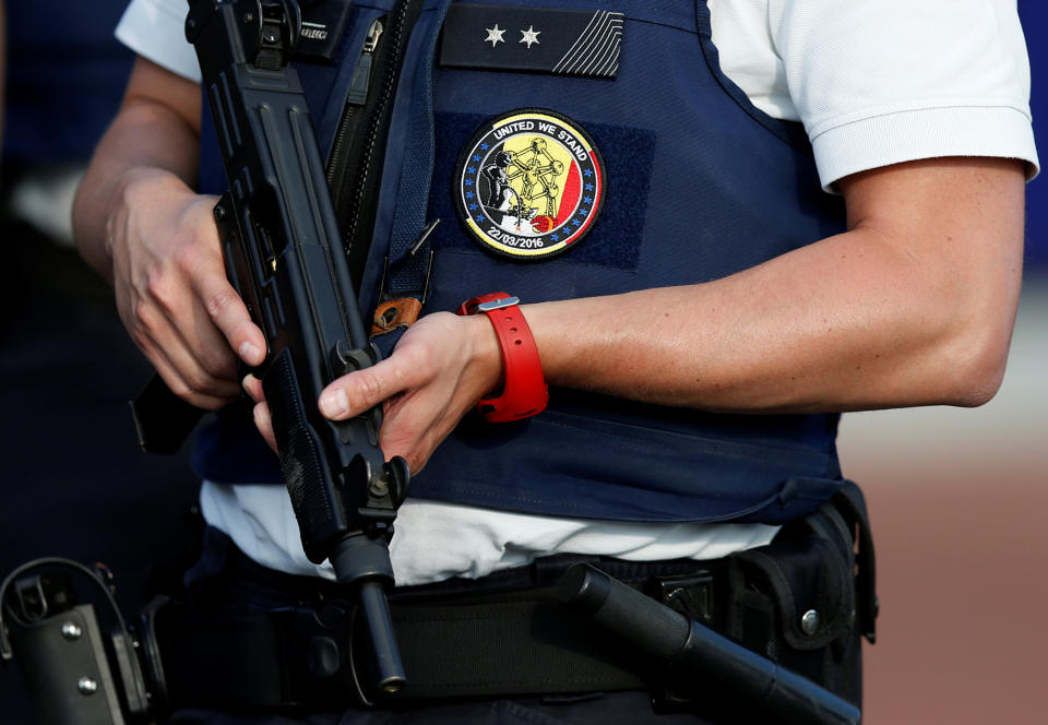 A Belgian police officer stands guard outside the main police station after a machete-wielding man injured two female police officers