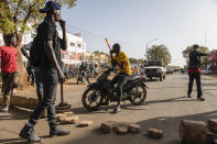 Protestors take to the streets of Burkina Faso's capital Ouagadougou Saturday Jan. 22, 2022, 27, 2021, protesting the government's inability to stop jihadist attacks spreading across the country and calling for President Roch Marc Christian Kabore to resign. (AP Photo/Sophie Garcia)