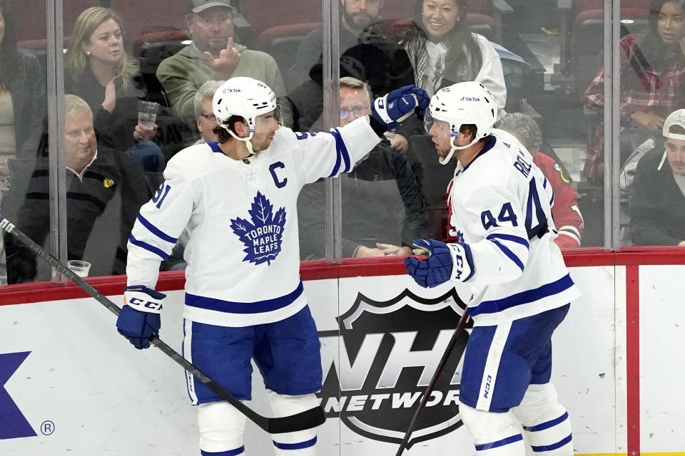 Toronto Maple Leafs' John Tavares, left, celebrates his goal with Morgan Rielly during the second period of an NHL hockey game against the Chicago Blackhawks Wednesday, Oct. 27, 2021, in Chicago. (AP Photo/Charles Rex Arbogast)