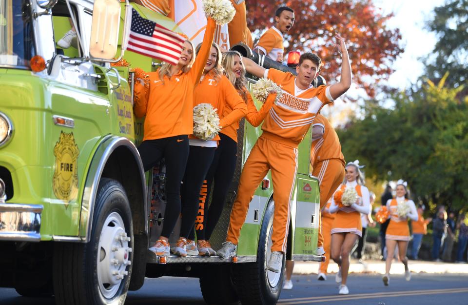 University of Tennessee cheerleaders and dance team ride in University of Tennessee homecoming parade on UT’s campus Friday, Nov. 12, 2021.