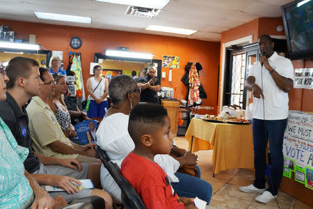 Candidate Andrew Gillum who is seeking the Democratic nomination for Florida governor, speaks to voters on a tour of barbershops in Sarasota, Florida, U.S., July 18, 2018. REUTERS/Letitia Stein