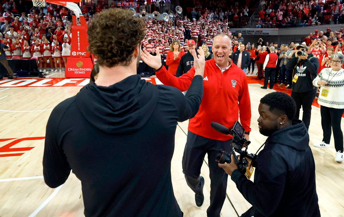 N.C. State head football coach Dave Doeren congratulates linebacker Payton Wilson after Wilson learned he won the Butkus Award during a timeout in the Wolfpack’s basketball game against Maryland Eastern Shore at Reynolds Coliseum in Raleigh, N.C., Wednesday, Dec. 6, 2023. Ethan Hyman/ehyman@newsobserver.com