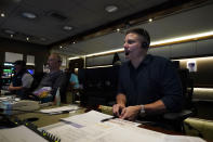 Producer Robert Hyland, right, and director Drew Esocoff work inside the NBC Sports trailer in preparation for the network's "Sunday Night Football" broadcast, before an NFL football game between the Los Angeles Chargers and the Miami Dolphins on Dec. 11, 2022, in Inglewood, Calif. “Sunday Night Football” is on pace to be prime time's top show for the 12th consecutive year. (AP Photo/Jae C. Hong)