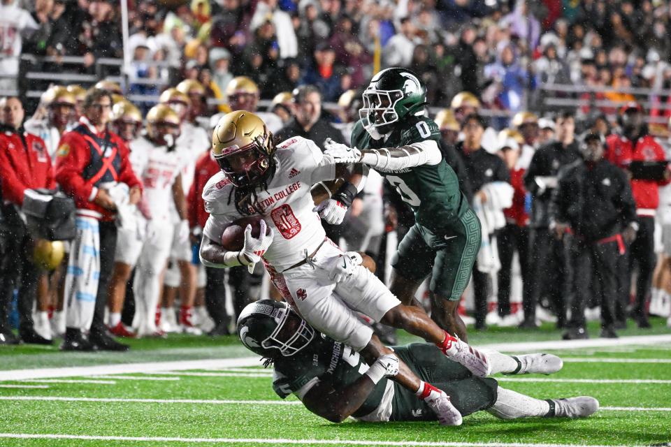 Sep 21, 2024; Chestnut Hill, Massachusetts, USA; Boston College Eagles running back Treshaun Ward (0) is tackled by Michigan State Spartans defensive back Charles Brantley (0) and linebacker Jordan Hall (5) during the first half at Alumni Stadium. Mandatory Credit: Eric Canha-Imagn Images