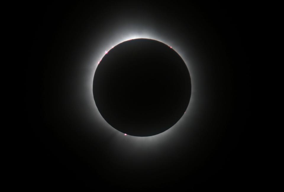 A total solar eclipse is viewed from the north patio of the Bayfront Convention Center in Erie on April 8, 2024.