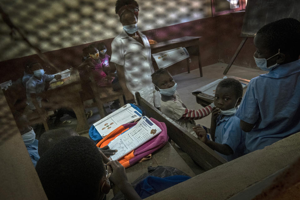 Displaced children attend a class in one of the educational centers set up by a local NGO in Pemba, Mozambique, after they fled attacks in Palma in Northern Mozambique, Monday April 19, 2021. The damage caused by Mozambique's extremist rebels in their deadly assault on the northeastern town of Palma continues to be assessed. More than three weeks after the rebels launched a three-pronged attack, which lasted at least five days, Mozambican police and relief agencies are working to help the thousands uprooted by the violence and restore the town to daily life.(AP Photo)