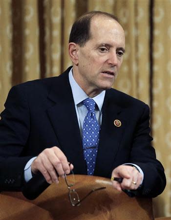 House Ways and Means Committee Chairman Rep. Dave Camp (R-MI) confers with another member of Congress before their hearing on President Barack Obama's FY2015 Budget Proposal in Washington, in this March 6, 2014 file photo. REUTERS/Gary Cameron