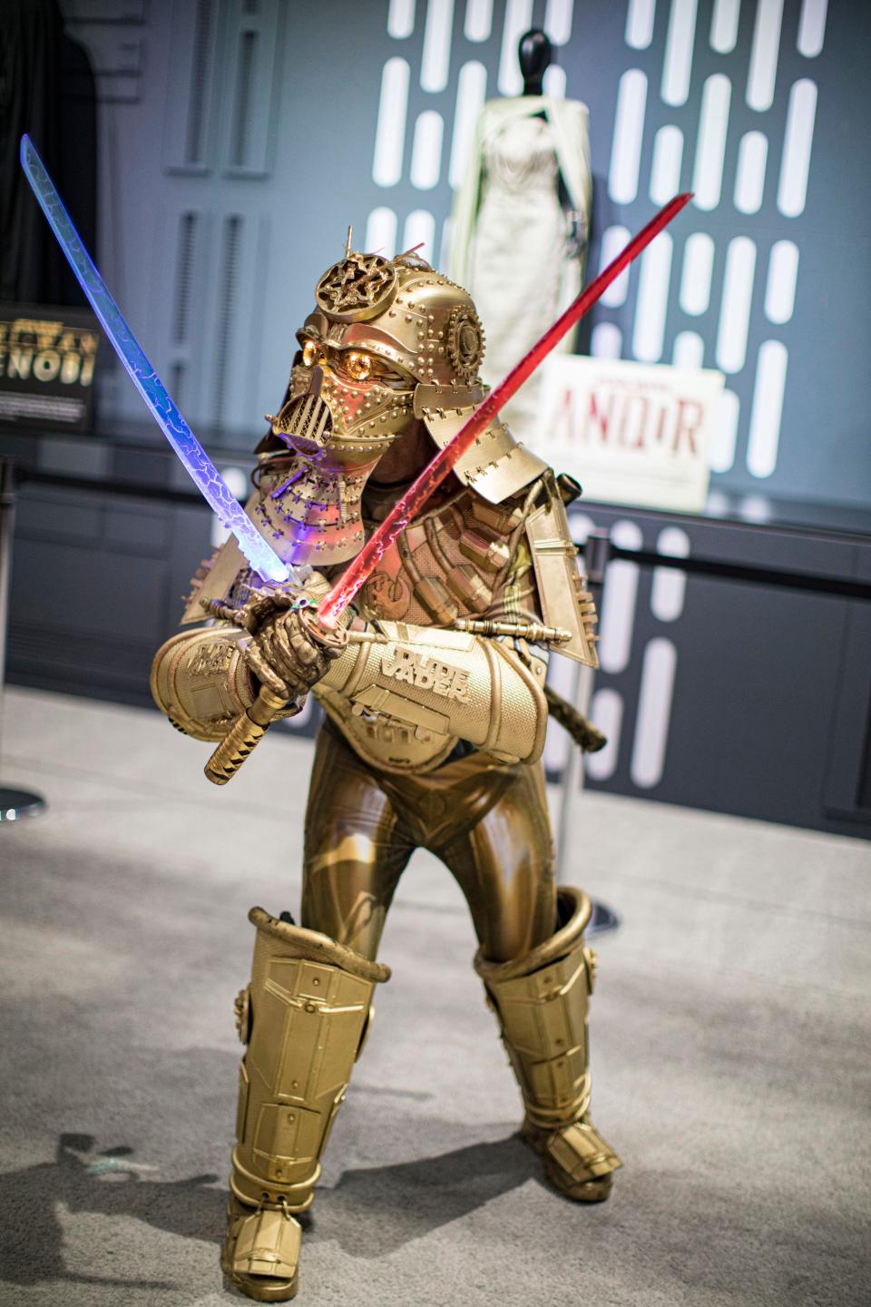 Star Wars cosplayer Christopher Canole as Dude Vader poses for photos at the Star Wars booth during 2022 Comic-Con International Day 4 at San Diego Convention Center on July 24, 2022 in San Diego, California.