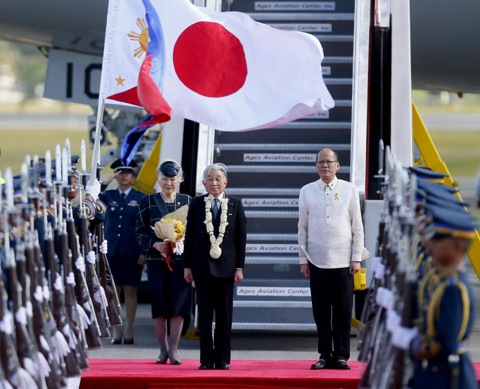 In this Jan. 26, 2016, file photo, Japan's Emperor Akihito, center, Empress Michiko, left, and Philippine President Benigno Aquino stand at attention as the national anthems are played upon their arrival in suburban Pasay city, south of Manila, Philippines. Akihito has made visits, unprecedented for a Japanese emperor, to the Philippines and other Pacific islands conquered by Japan early in World War II and devastated in fierce fighting as the U.S.-led allies took them back. (AP Photo/Bullit Marquez, File)