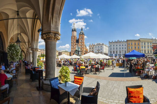 Krakow full of tourists having a coffee break under the archs of the Cloth Hall