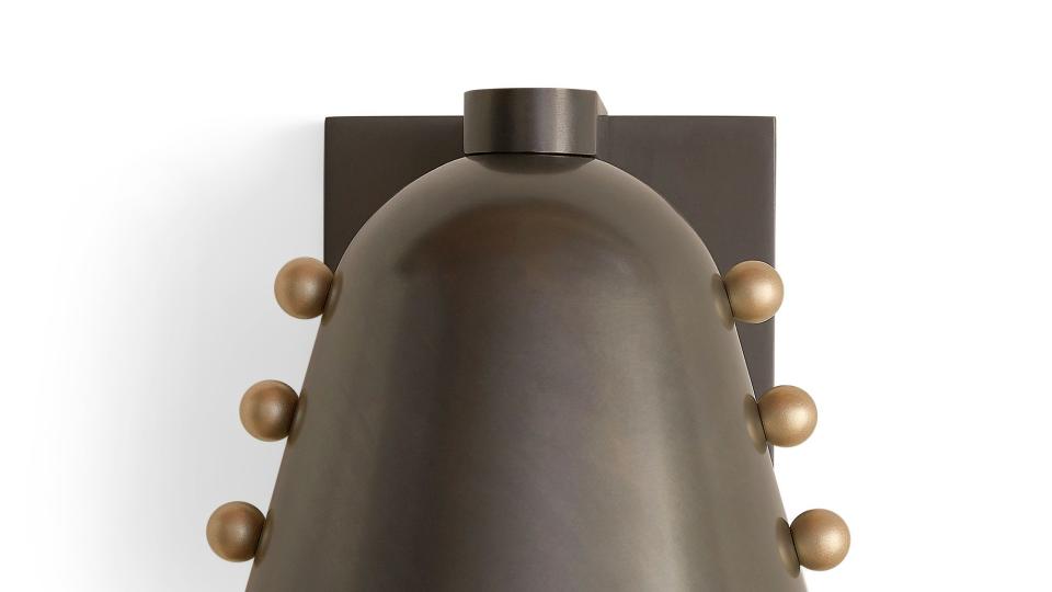 bell shaped sconce with round things along the sides that make it look a little like a dalek