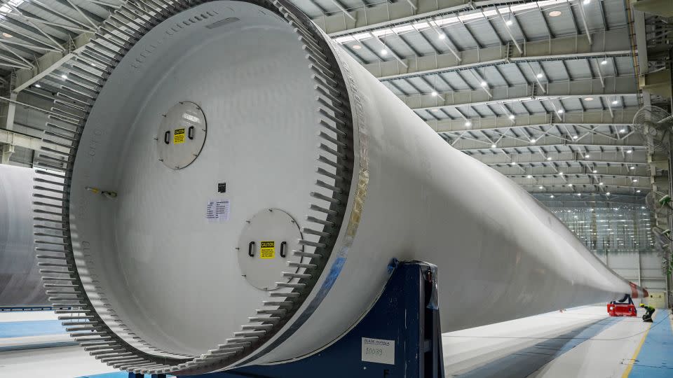 An employee working on a blade for a wind turbine produced at an Adani Group factory in the Indian city of Mundra. - Punit Paranjpe/AFP/Getty Images