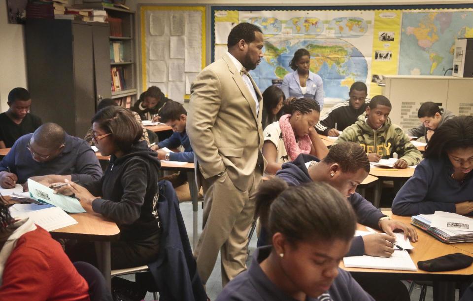 FILE - In this Dec. 3, 2013 file photo, Adofo Muhammad, center, principal of Bedford Academy High School, teaches 10th and 11th graders in his Global Studies class in the Brooklyn Borough of New York. New York state has the most segregated public schools in the nation, with many black and Latino students attending schools with virtually no white classmates, according to a report released Wednesday, March 26, 2014, by the Civil Rights Project at the University of California at Los Angeles. (AP Photo/Bebeto Matthews, File)