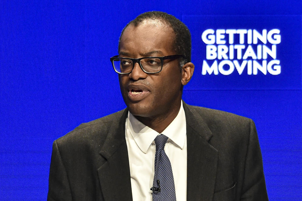 Britain's Chancellor of the Exchequer Kwasi Kwarteng speaks at the Conservative Party conference at the ICC in Birmingham, England, Monday, Oct. 3, 2022. The British government has dropped plans to cut income tax for top earners, part of a package of unfunded cuts that sparked turmoil on financial markets and sent the pound to record lows. (AP Photo/Rui Vieira)