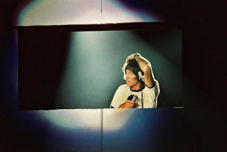 Roger Waters performs from behind a hole in The Wall onstage