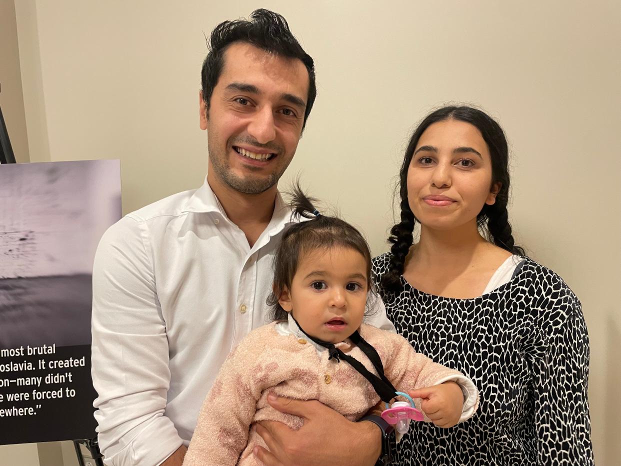 Selami Buzluk and his wife, Lutfiye, stand with their 16-month-old daughter, Ikra, after an event highlighting immigration to the South Bend-Elkhart region. The couple moved to the U.S. from Turkey so that Buzluk could pursue his master's degree in engineering.