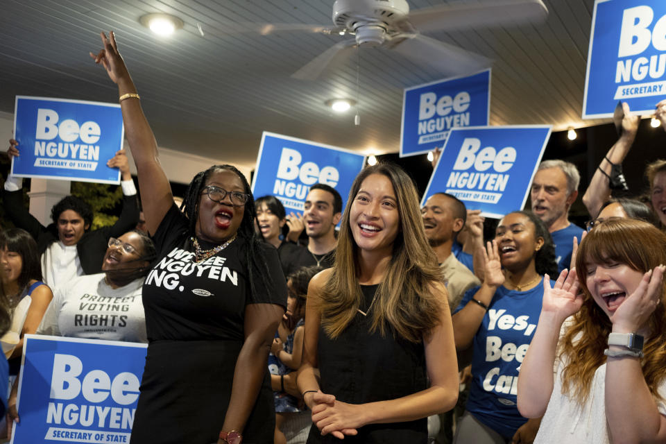 CORRECTS MONTH TO JUNE INSTEAD OF JANUARY - Georgia state Rep. Bee Nguyen, center, celebrates Tuesday, June 21, 2022, in Atlanta, after winning a runoff election to be the Democratic candidate for Georgia Secretary of State. (AP Photo/Ben Gray)