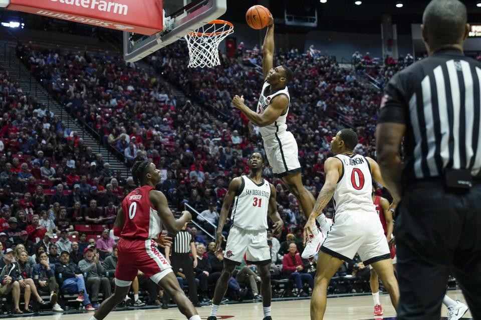 San Diego State guard Lamont Butler dunks during the first half of an NCAA college basketball game against UNLV Saturday, Feb. 11, 2023, in San Diego. (AP Photo/Gregory Bull)