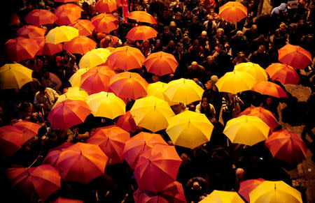 Protesters shout slogans while holding red and yellow umbrellas during demonstrations against an agreement that would ensure the wider official use of the Albanian language, in Skopje, Macedonia, March 1, 2017. REUTERS/Stringer