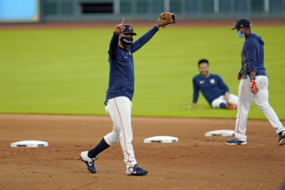 Houston Astros first baseman Yuli Gurriel reacts after completing a drill during a baseball practice at Minute Maid Park, Sunday, July 5, 2020, in Houston. (AP Photo/David J. Phillip)