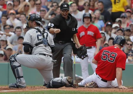 Jul 16, 2017; Boston, MA, USA; Boston Red Sox first baseman Sam Travis (59) tagged out at home plate by New York Yankees catcher Austin Romine (27) in the second inning at Fenway Park. Mandatory Credit: David Butler II-USA TODAY Sports