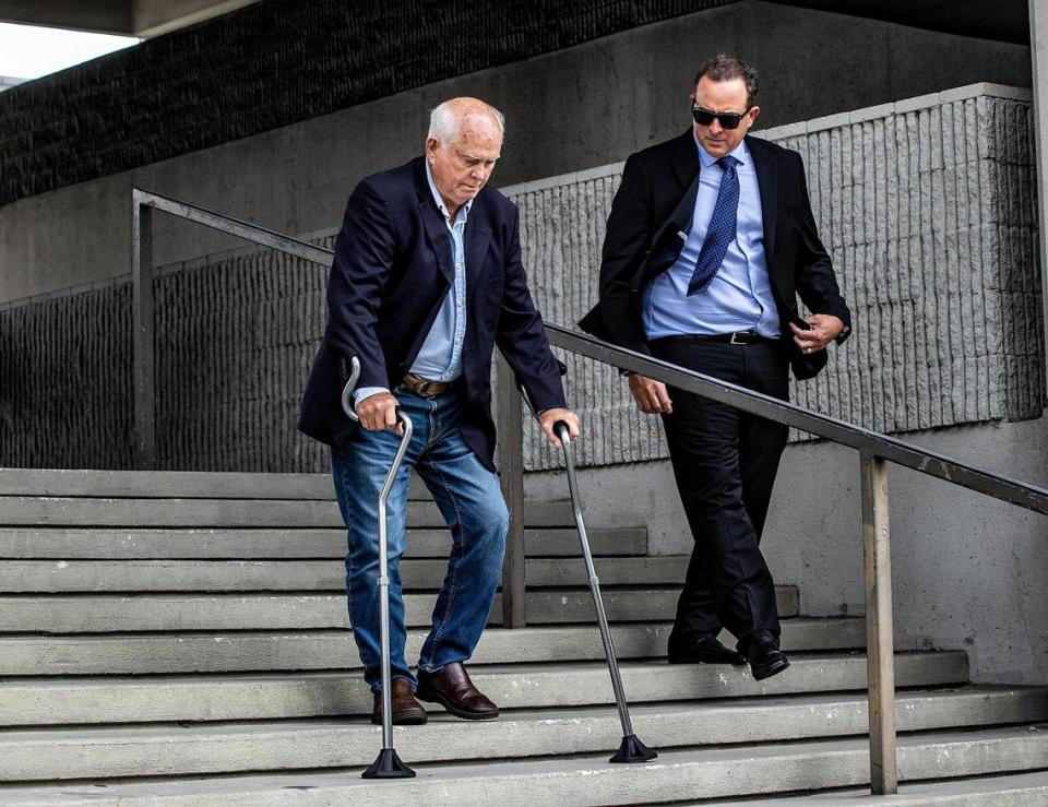 William “Bill” Fuller (right) and his father Fred Fuller walk out of the Broward County Federal Court House after the second day of the Federal civil trial pitting Fuller and his partner against Miami City Commissioner Joe Carollo.