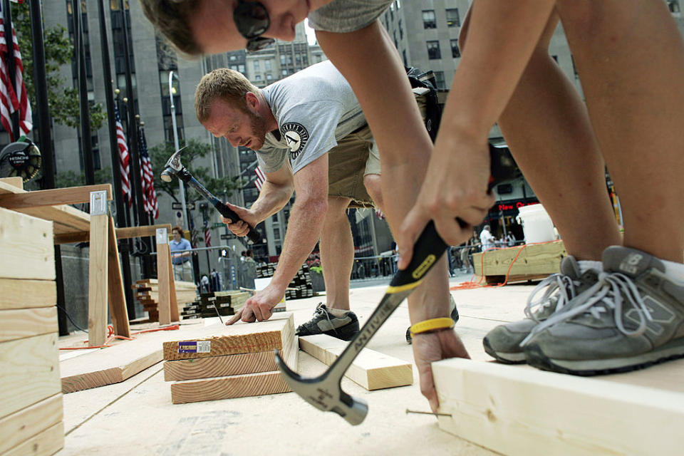 People using hammers on wood