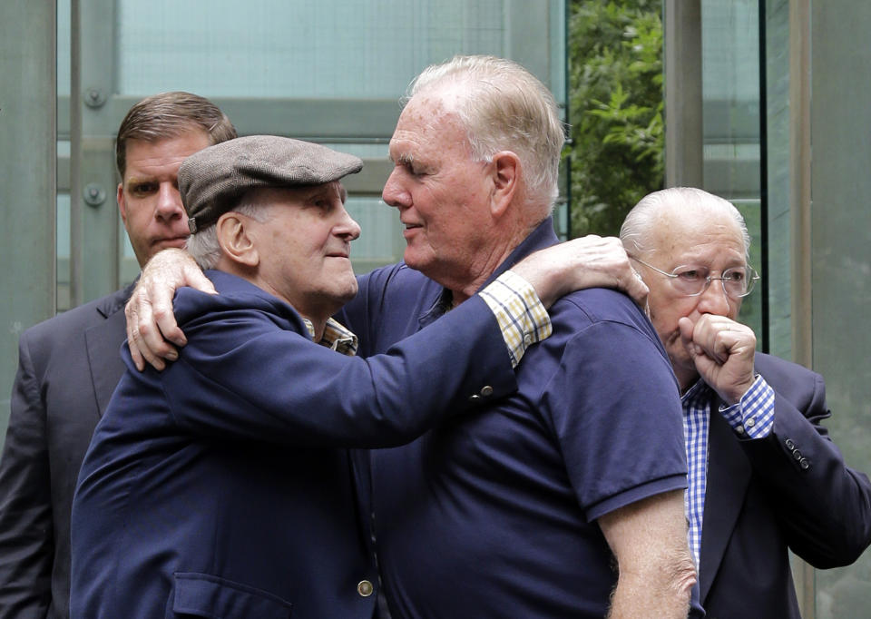 FILE - In this July 11, 2017, file photo, Holocaust survivor Steve Ross, left, founder of the New England Holocaust Memorial, embraces former Boston Mayor Raymond Flynn during a a rededication ceremony for the repaired New England Holocaust Memorial in Boston. Ross, a Holocaust survivor who spent decades searching for the soldier who helped him at a concentration camp in 1945, died Monday, Feb. 24, 2020, Boston Mayor Marty Walsh said in a tweet. (AP Photo/Elise Amendola, File)