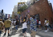 Baseball fans celebrate as the gates open up before a baseball game between the Arizona Diamondbacks and the San Diego Padres Thursday, April 1, 2021, on opening day in San Diego. (AP Photo/Denis Poroy)