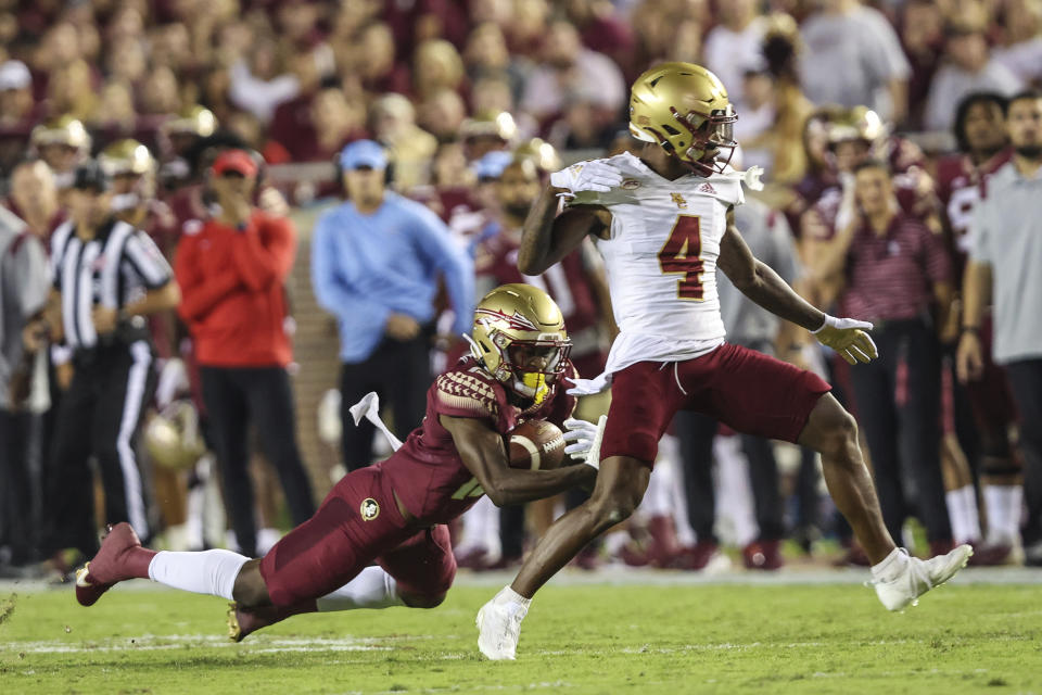 Florida State defensive back Omarion Cooper (13) intercepts a pass to Boston College wide receiver Zay Flowers (4) during the first quarter of an NCAA college football game on Saturday, Sept. 24, 2022, in Tallahassee, Fla. (AP Photo/Gary McCullough)